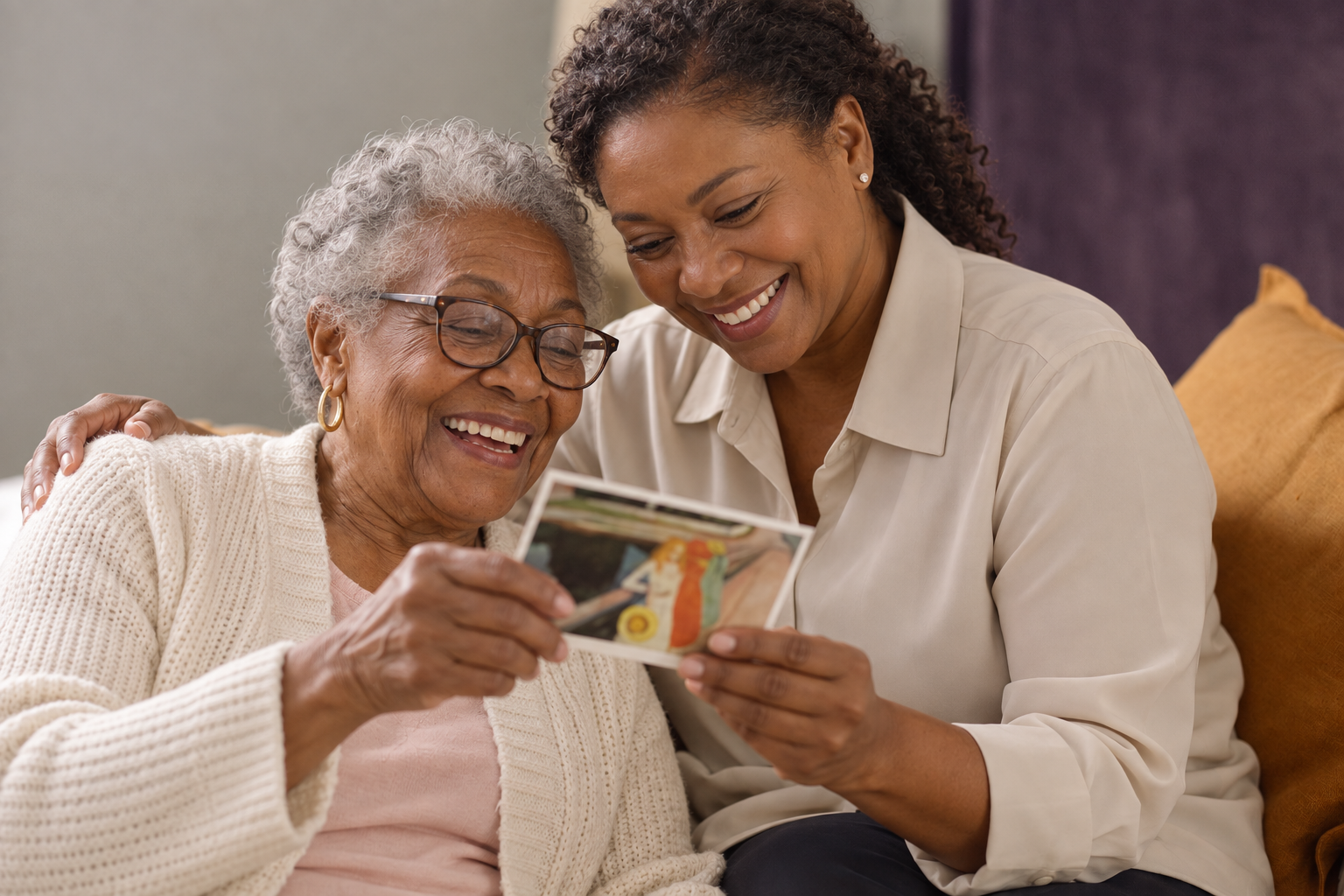 Two older adults sharing a happy moment at home